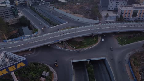 Early-morning-sunrise-drone-orbiting-at-the-Mindspace-Rotary-Junction-revealing-the-Mindspace-Flyover-and-Ikea-Store-sign,-Hyderabad