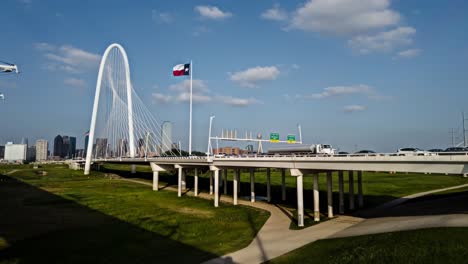 Timelapse-or-motionlapse-of-the-Margaret-Hunt-Hill-Bridge-located-in-dallas,-texas,-USA,-with-vehicles-and-people-crossing-the-bridge-with-the-clouds-moving