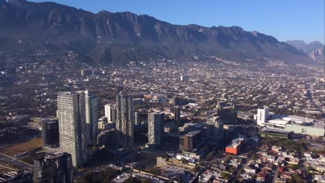 Aerial-tour-of-buildings-in-the-city-of-Monterrey,-spring,-sunny-day,-dolly-in