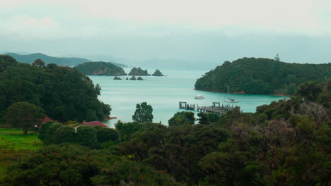 Slow-motion-wide-shot-of-dock-with-islands-in-the-background-at-Urupukapuka-Island,-New-Zealand