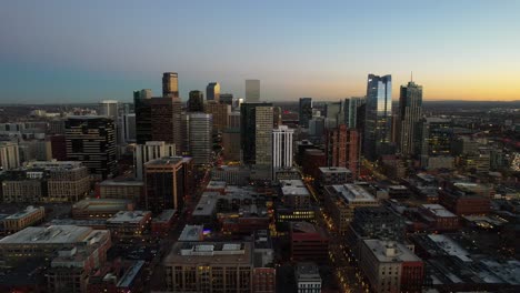 Aerial-over-the-Denver-skyline-at-dusk,-Colorado,-USA