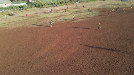 Football-game-in-Africa-on-arid-pitch-in-Loitokitok,-Kenya,-aerial-view