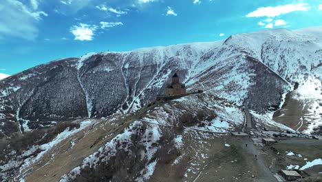 Gergeti-Trinity-Church-And-Kazbegi-Mountain-In-Georgia---aerial-drone-shot