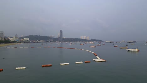 Ascending-4k60-aerial-view-of-Pratumnak-Hill-and-the-pier-with-speedboats-to-Koh-Lorn