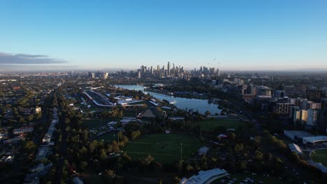 Downtown-Melbourne-with-skyscrapers-skyline-during-sunrise,-aerial-backwards