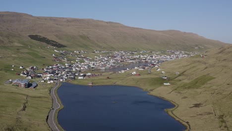 Panorama-drone-shot-of-Vagur-town-in-The-Valley-on-Suduroy-island-during-sunny-day---visiting-Faroe-Islands