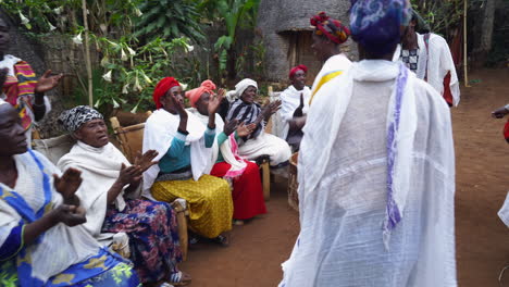 Ethiopian-Dorze-tribal-people-dancing-and-making-music-in-front-of-a-hut-with-a-woman-smiling-and-enjoying-herself