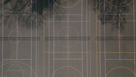 Aerial-top-down-view-of-a-black-tennis-court