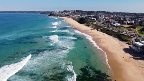 Aerial-drone-landscape-view-pan-of-Merewether-Beach-surfing-clear-ocean-sea-beach-travel-tourism-Newcastle-NSW-Australia-coastline-4K