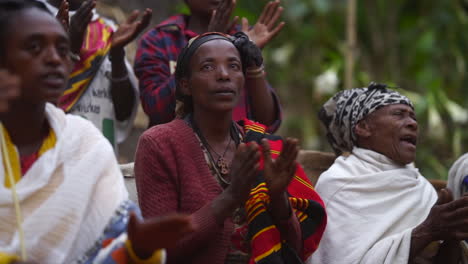 Medium-shot-Dorze-tribal-woman-in-Ethiopia-clapping-on-traditional-music-in-slow-motion