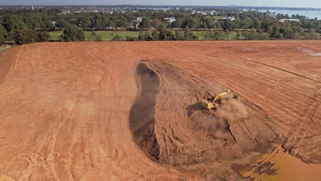 Yarrawonga,-Victoria,-Australia---18-April-2023:-Aerial-showing-big-excavator-working-at-moving-earth-in-golf-club-earthworks-at-Yarrawonga