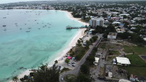 Drone-flying-over-the-coastline-of-a-Barbados-town