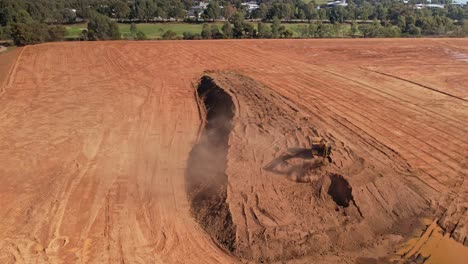 Yarrawonga,-Victoria,-Australia---18-April-2023:-Excavator-moving-around-with-bucket-of-dirt-and-revealing-work-site-at-Black-Bull-Golf-Course-in-Yarrawonga