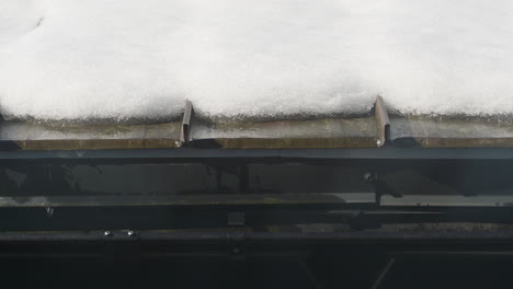 Timelapse-of-snow-melting-off-of-a-roof-due-to-rapidly-rising-Spring-temperatures