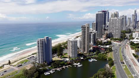 Surfers-Paradise,-Queensland-Australia---February-28-2021:-Aerial-looking-south-to-Surfers-Paradise-with-the-Pacific-Ocean-and-high-rise-buildings-along-the-Gold-Coast-strip