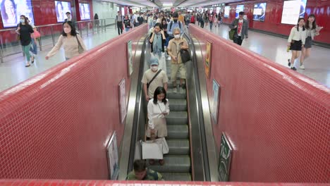 Commuters-ride-on-an-automatic-moving-escalator-at-a-subway-station