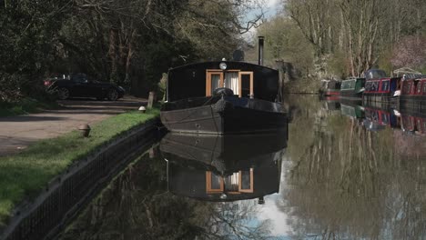 Black-widebeam-boat-moored-on-a-canal