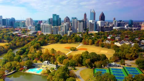 Aerial-drone-shot-slowly-circling-around-Piedmont-Park-near-downtown-Atlanta,-Georgia-looking-down-on-the-swimming-pools,-tennis-courts,-and-softball-fields