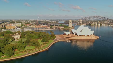 Sydney,-New-South-Wales,-Australia---25-December-2021:-Aerial-approaching-the-Sydney-Opera-House-and-the-Sydney-Harbour-Bridge-over-Sydney-Harbour