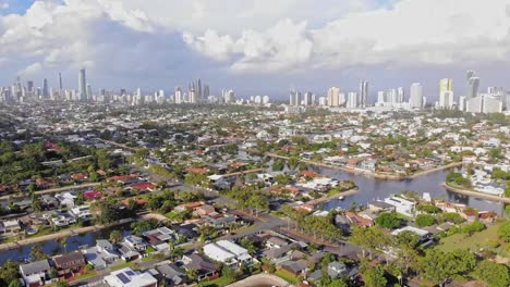 Broadbeach-Waters,-Queensland,-Australia---24-February-2021:-Pan-from-Broadbeach-Waters-showing-canals-and-Surfers-high-rise-in-the-background