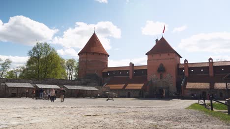 Trakai,-Lithuania-4-May-2023:-Tourists-Visiting-Trakai-Gothic-Island-Castle-Inner-Yard,-Museum-and-a-Cultural-Centre-POV,-Steadicam-Shot