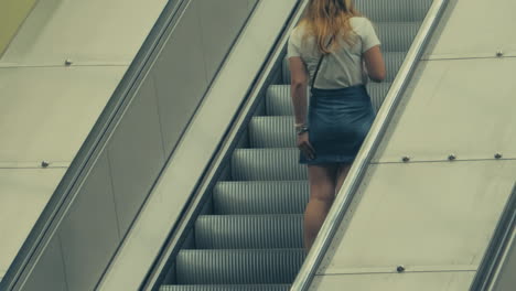 A-Shot-Of-A-Young-Woman-Fixing-Her-Skirt-On-Her-Way-Up-An-Escalator-In-The-Subway-Of-Stockholm,Sweden