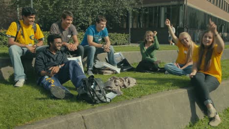 Students-smile-and-cheer-for-the-camera-as-they-enjoy-a-warm-day-on-the-campus-of-Chalmers-University