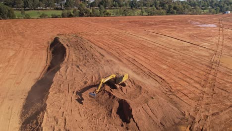 Yarrawonga,-Victoria,-Australia---18-April-2023:-Large-tracked-excavator-moving-on-its-tracks-then-loading-and-unloading-dirt-at-earthworks-site-in-Yarrawonga