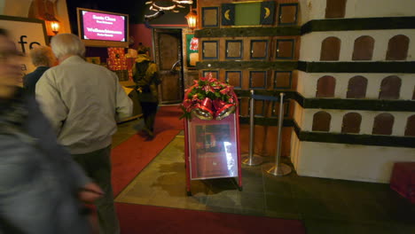 Various-people-of-different-ages-walking-by-and-entering-the-Santa-Claus-Cafe-in-Santa-Claus-Village