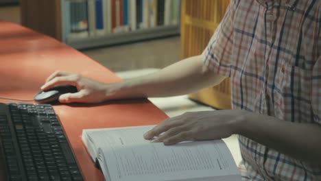 Close-up-view-of-a-young-man-working-in-the-college-library