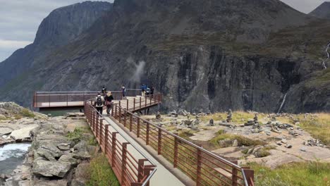 Group-of-tourists-walking-over-the-viewing-platform-in-Trollstigen-in-slow-motion