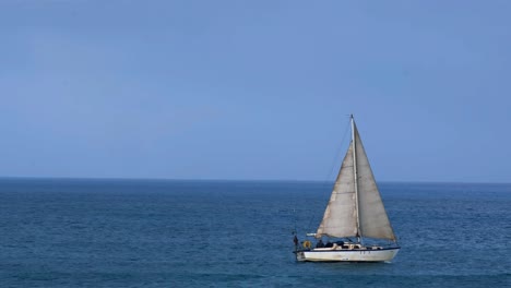 An-ocean-yacht-sailing-across-a-calm-sea-with-birds-flying-in-the-background