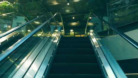 Dreamy-sleek-way-to-the-first-floor-of-a-mall,-on-a-moving-escalator-in-Stockholm,-slow-motion-shot