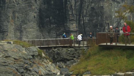 Close-up-view-people-walking-over-the-platforms-of-Trollstigen-in-slow-motion