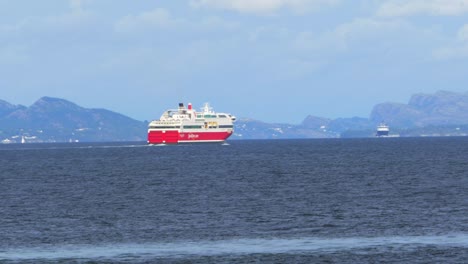 A-large-red-and-white-commercial-ferry-is-used-to-transport-passengers,-vehicles-and-commercial-goods-across-the-fjords-of-Norway