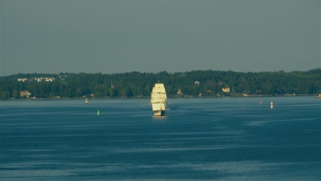 Wide-angle-view-of-a-large-sailing-ship-with-two-masts-and-multiple-sail-makes-way-through-the-Stockholm-Archipelago