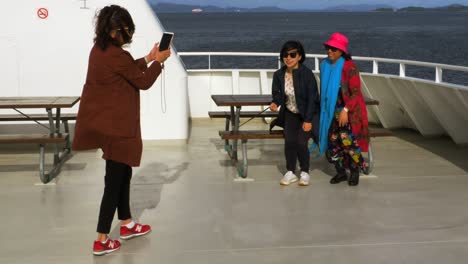 A-group-of-Asian-women-pose-for-photos-during-their-ferry-ride