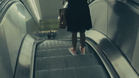 A-Shot-Of-A-Woman-On-An-Downwards-Moving-Escalator-To-The-Subway-Of-Stockholm,Sweden