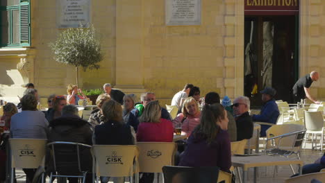 Tourists-relaxing-and-drinking-at-a-outdoor-cafe-in-the-interiors-of-the-city-of-Gozo,-Malta