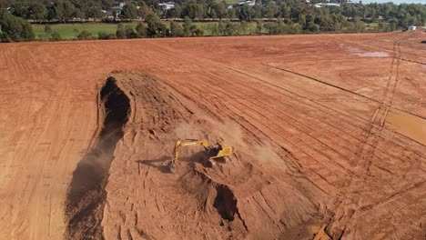 Yarrawonga,-Victoria,-Australia---18-April-2023:-Large-tracked-excavator-reaching-out-and-scooping-a-large-bucket-of-dirt-at-building-site-in-Yarrawonga