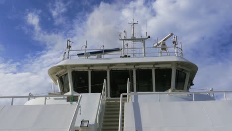 Mid-view-of-the-bridge-of-a-ferry-boat-with-antennas-and-radar-equipment-on-the-roof