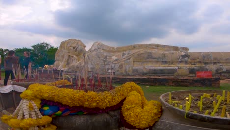 Incense-burns-in-front-of-the-reclining-Buddha-at-the-Wat-Lokayasutharam-temple