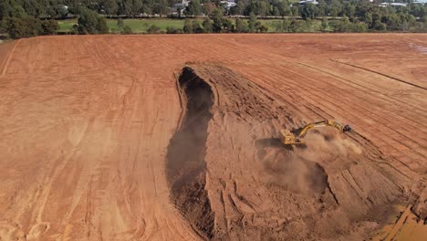 Yarrawonga,-Victoria,-Australia---18-April-2023:-Overhead-of-a-large-excavator-moving-around-loading-and-unloading-dirt-at-earthworks-site-in-Yarrawonga