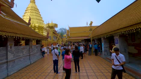 Exploring-the-Wat-Phrathat-Doi-Suthep-temple,-where-tour-guides-show-people-around-the-golden-structures
