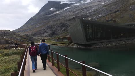 Tourists-walking-over-a-modern-path-near-the-information-center-of-Trollstiegen