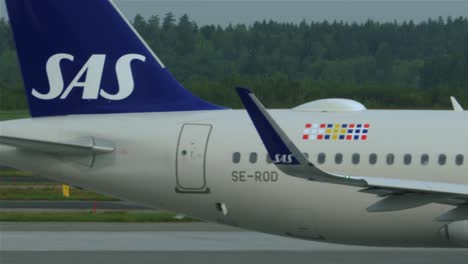 A-small-aircraft-heading-for-the-runway,-disappearing-behind-a-larger-airplane-at-Stockholm-Arlanda