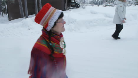 Reindeer-And-Sami-Walking-On-Snowy-Trail