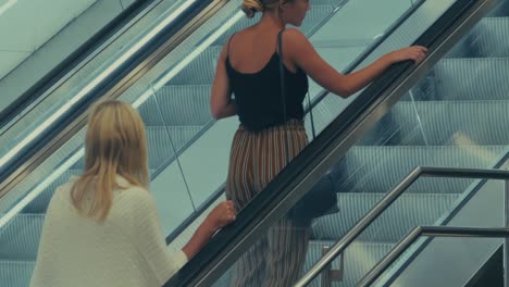 Two-Women-Going-Upwards-On-A-Subway-Escalator-In-Stockholm
