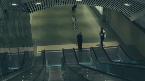 A-MOVING-SHOT-In-An-Downwards-Moving-Escalator-With-Some-People-Stepping-Onto-The-Escalator-In-Metro-Of-Stockholm