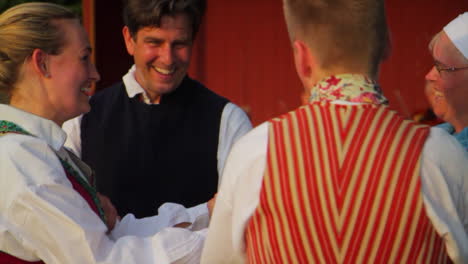 Beautiful-and-graceful-Swedish-folk-dancing-presented-live-on-stage-in-the-tradition-of-celebrating-Midsummer-as-musicians-play-the-violin